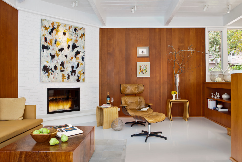 This is an example of a midcentury living room in San Francisco with a brick fireplace surround, a corner fireplace and white floor.