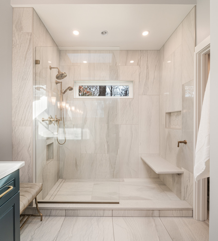 This is an example of a mid-sized transitional master bathroom in Other with shaker cabinets, blue cabinets, an open shower, a one-piece toilet, gray tile, ceramic tile, grey walls, mosaic tile floors, an undermount sink, engineered quartz benchtops, grey floor, an open shower, grey benchtops, a shower seat, a double vanity and decorative wall panelling.