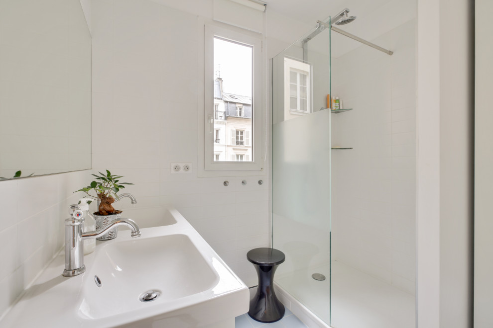 Photo of a small contemporary master bathroom in Paris with louvered cabinets, white cabinets, a double shower, a two-piece toilet, brown tile, cement tile, white walls, medium hardwood floors, a trough sink, tile benchtops, a sliding shower screen, white benchtops, a double vanity, a freestanding vanity and timber.