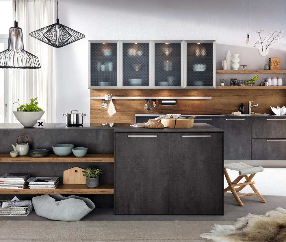Design ideas for a mid-sized contemporary galley open plan kitchen in Hamburg with a drop-in sink, flat-panel cabinets, black cabinets, brown splashback, timber splashback, concrete floors, with island, grey floor and black benchtop.