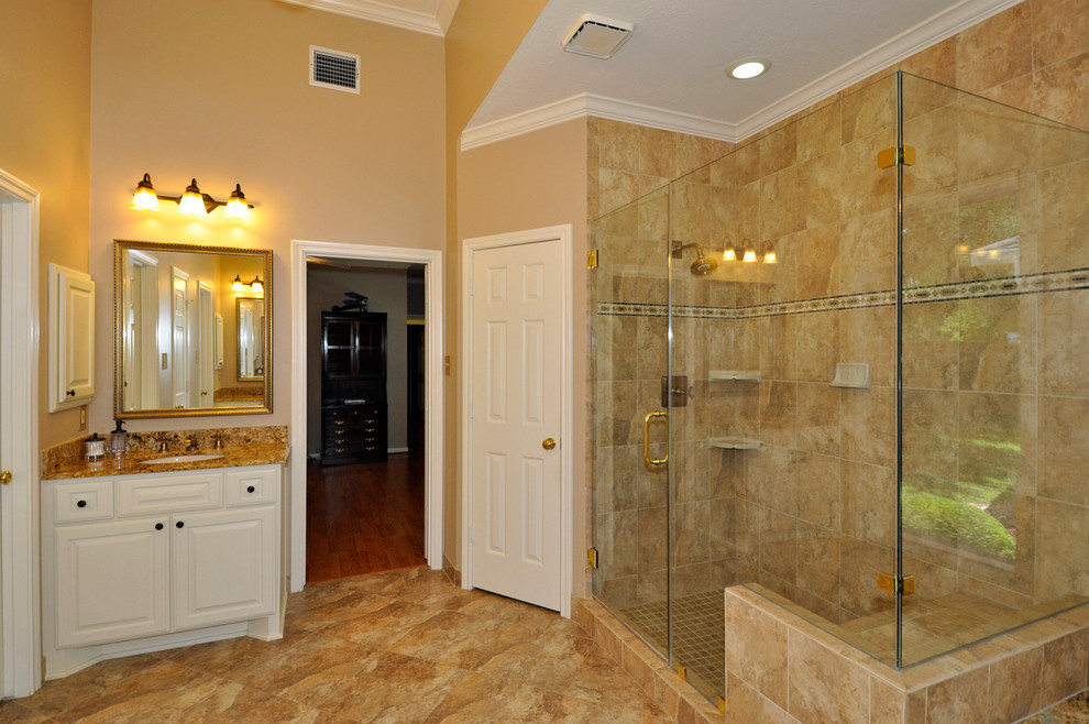 Design ideas for a large traditional master bathroom in Houston with an undermount sink, raised-panel cabinets, white cabinets, a hot tub, a corner shower, beige tile, beige walls, ceramic tile, travertine floors and laminate benchtops.