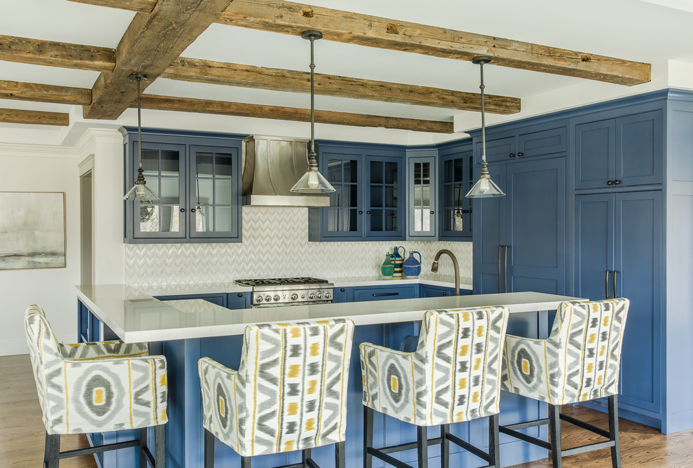 Inspiration for a farmhouse dark wood floor kitchen remodel in Boston with glass-front cabinets, blue cabinets, quartz countertops, multicolored backsplash, stone tile backsplash, stainless steel appliances and an island