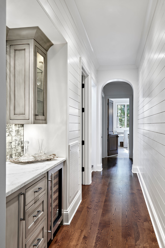 Design ideas for a mid-sized transitional hallway in Nashville with white walls and medium hardwood floors.