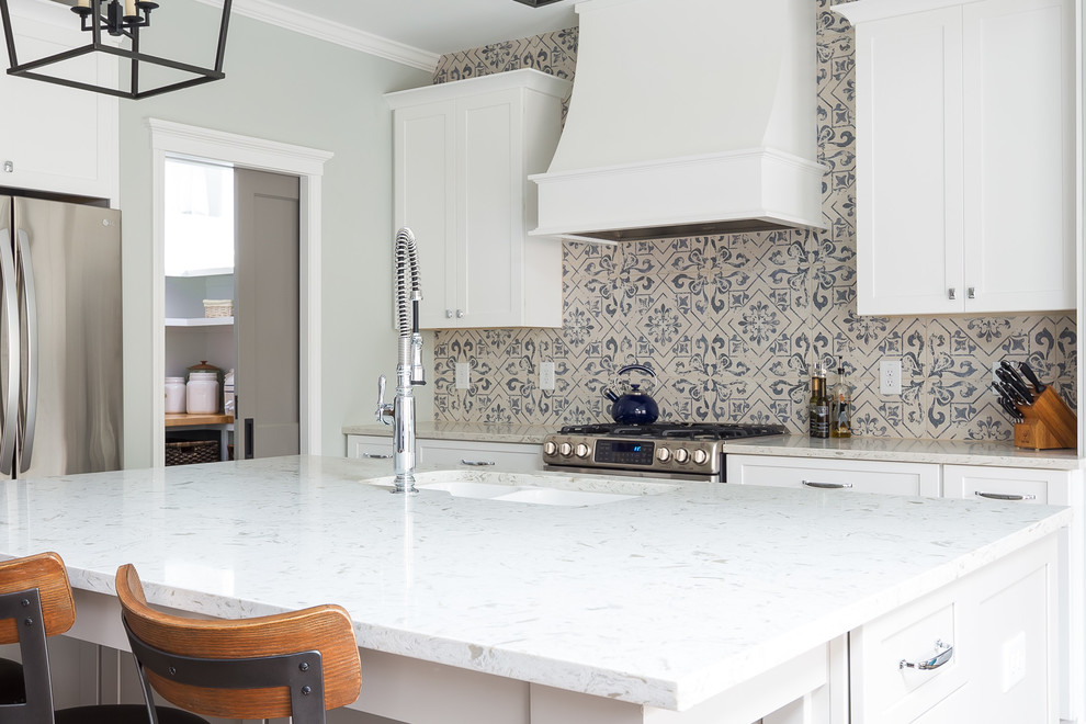 Eat-in kitchen - mid-sized transitional l-shaped porcelain tile and white floor eat-in kitchen idea in Raleigh with an undermount sink, shaker cabinets, white cabinets, multicolored backsplash, porcelain backsplash, stainless steel appliances, an island, wood countertops and white countertops
