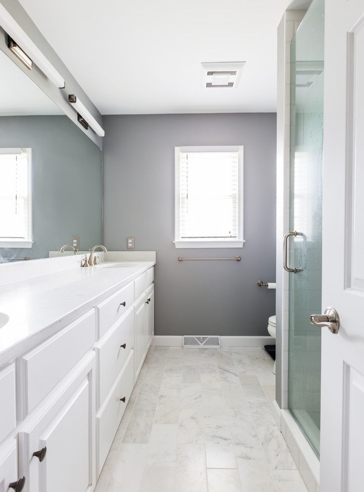 Inspiration for a small traditional master bathroom in Other with raised-panel cabinets, white cabinets, gray tile, grey walls, marble floors, engineered quartz benchtops and white floor.