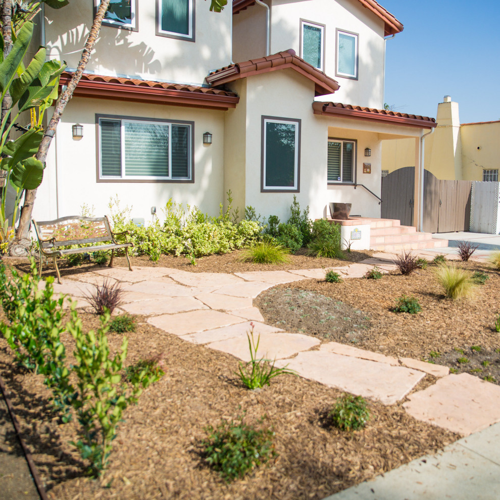 Photo of a small contemporary front yard full sun xeriscape for fall in Los Angeles with a garden path and natural stone pavers.