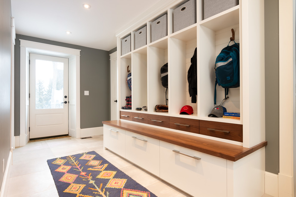 Inspiration for a transitional mudroom in Toronto with porcelain floors, grey walls, a single front door, a white front door and beige floor.