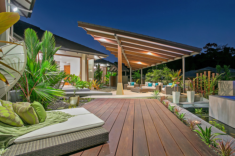 Photo of a tropical front yard patio in Cairns with a water feature, decking and a gazebo/cabana.