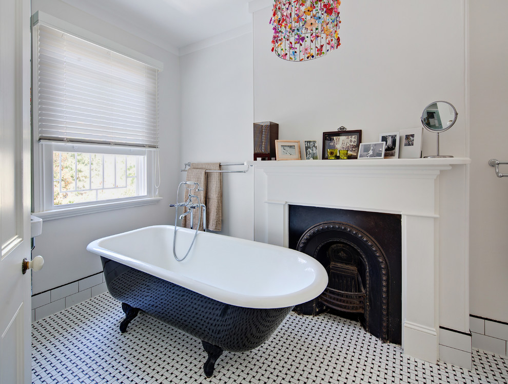 This is an example of a small traditional master bathroom in Sydney with a claw-foot tub, white walls and ceramic floors.