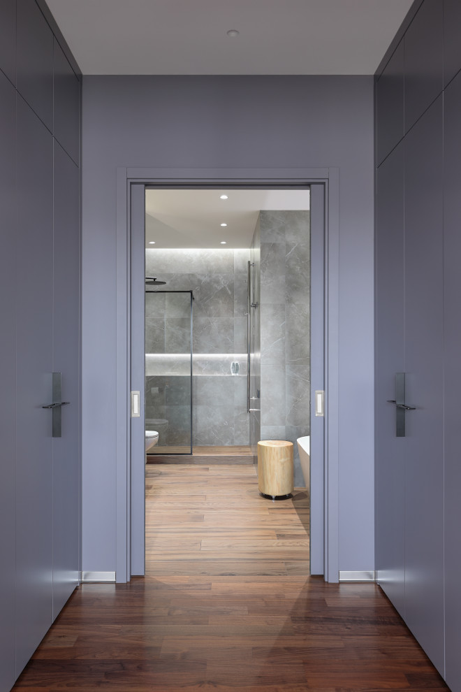 Photo of a mid-sized scandinavian master bathroom in Saint Petersburg with flat-panel cabinets, grey cabinets, a freestanding tub, an alcove shower, a wall-mount toilet, gray tile, porcelain tile, grey walls, wood-look tile, a vessel sink, wood benchtops, brown floor, a shower curtain, brown benchtops, a single vanity and a freestanding vanity.