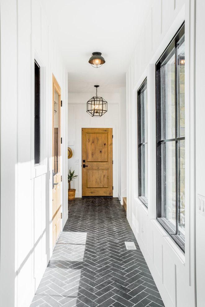 Inspiration for a large country hallway in Salt Lake City with white walls, slate floors and black floor.