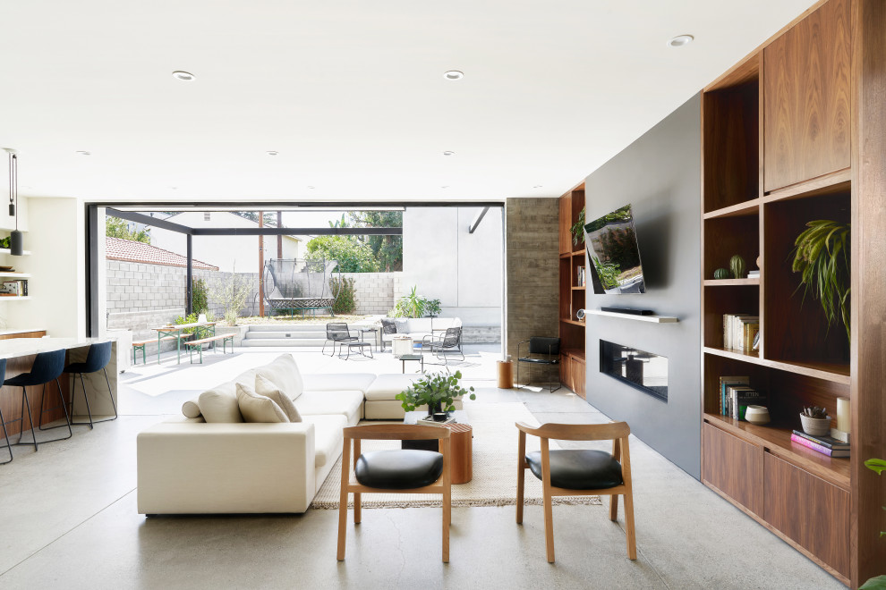 Idee per un soggiorno design di medie dimensioni con pavimento in cemento e pavimento grigio