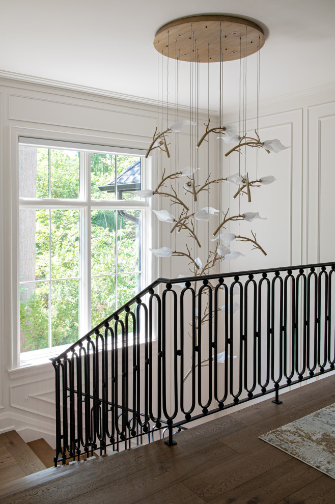 Inspiration for a large transitional u-shaped metal railing and wall paneling staircase remodel in Toronto