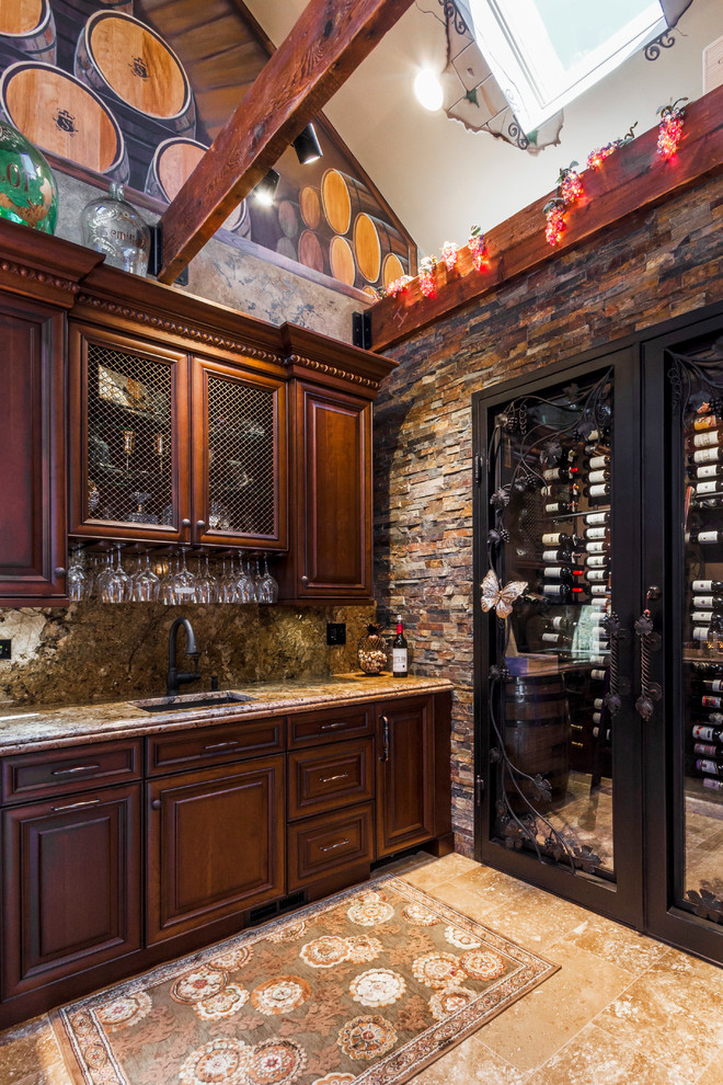 This is an example of a large mediterranean wine cellar in Chicago with display racks and travertine floors.