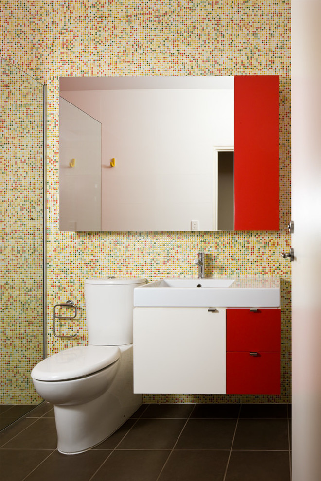 Photo of a contemporary bathroom in Adelaide with a console sink, flat-panel cabinets, white cabinets, a curbless shower, multi-coloured tile and mosaic tile.