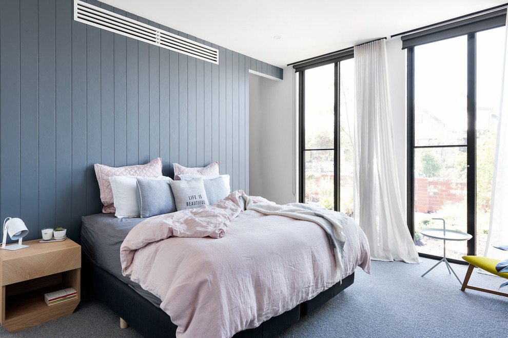 This is an example of a mid-sized contemporary master bedroom in Melbourne with white walls, carpet and grey floor.