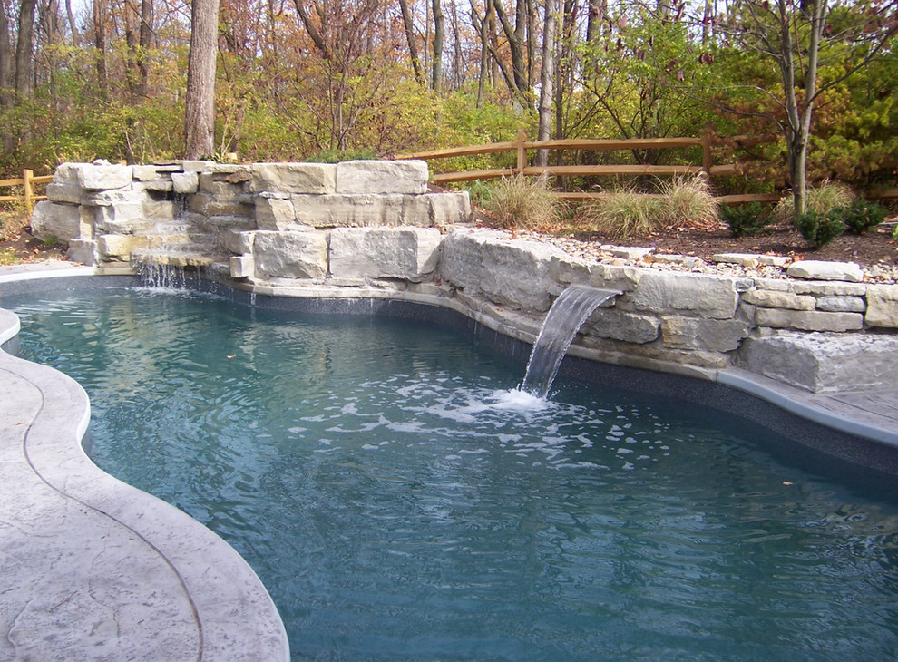 Pool fountain - large backyard stone and custom-shaped natural pool fountain idea in Cincinnati