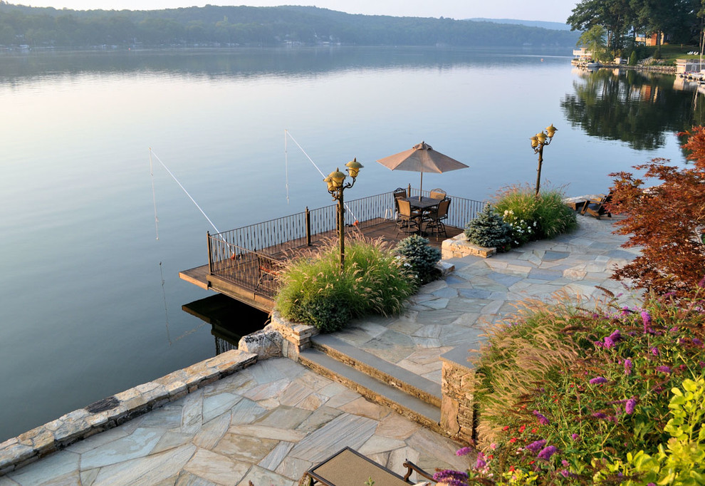 Inspiration for a large beach style backyard deck in New York with with dock and no cover.