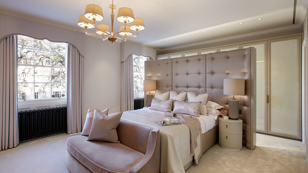Photo of a large transitional master bedroom in London.