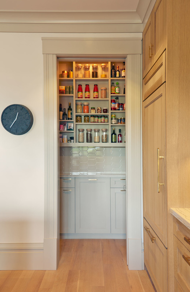 Transitional l-shaped kitchen pantry in San Francisco with an undermount sink, white splashback, ceramic splashback, panelled appliances and with island.