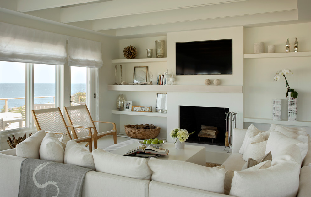 Inspiration for a beach style formal open concept living room in Boston with beige walls, a standard fireplace and a wall-mounted tv.