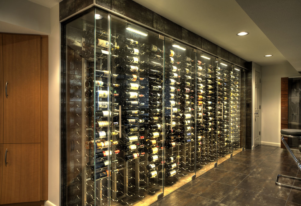 Large contemporary wine cellar in Wichita with vinyl floors, display racks and black floor.