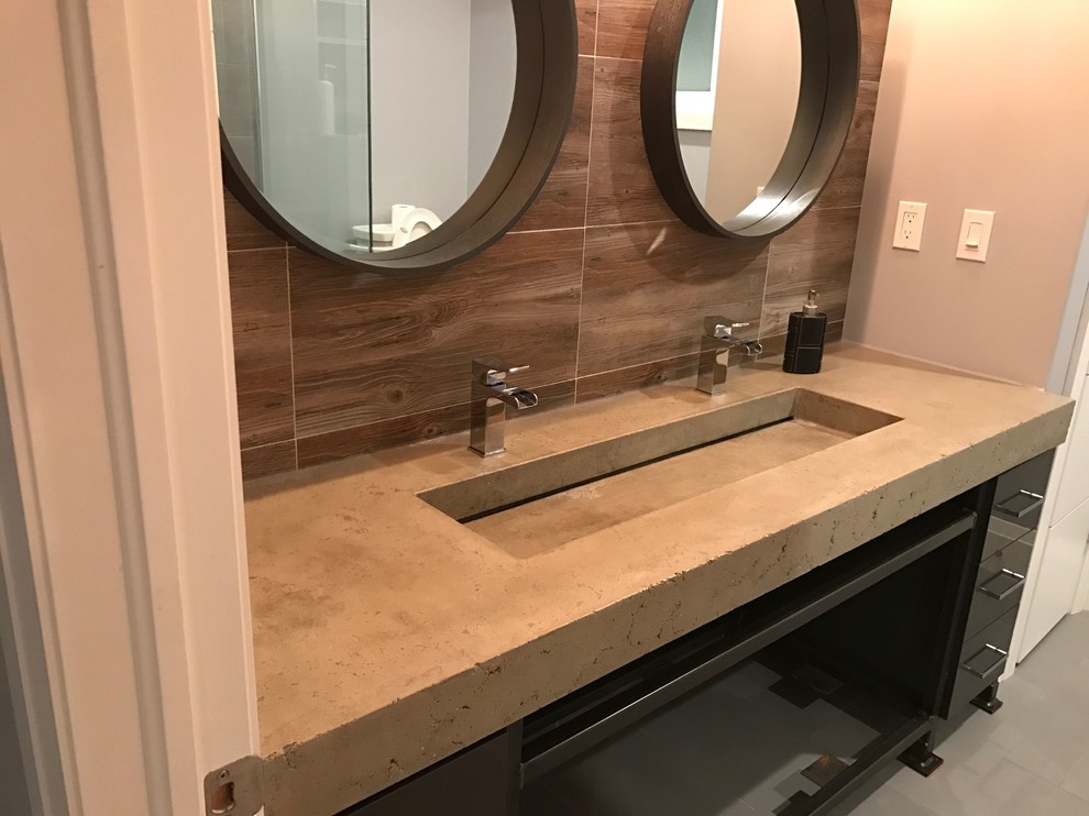 Bathroom - rustic brown tile and ceramic tile bathroom idea with gray walls, a trough sink and concrete countertops