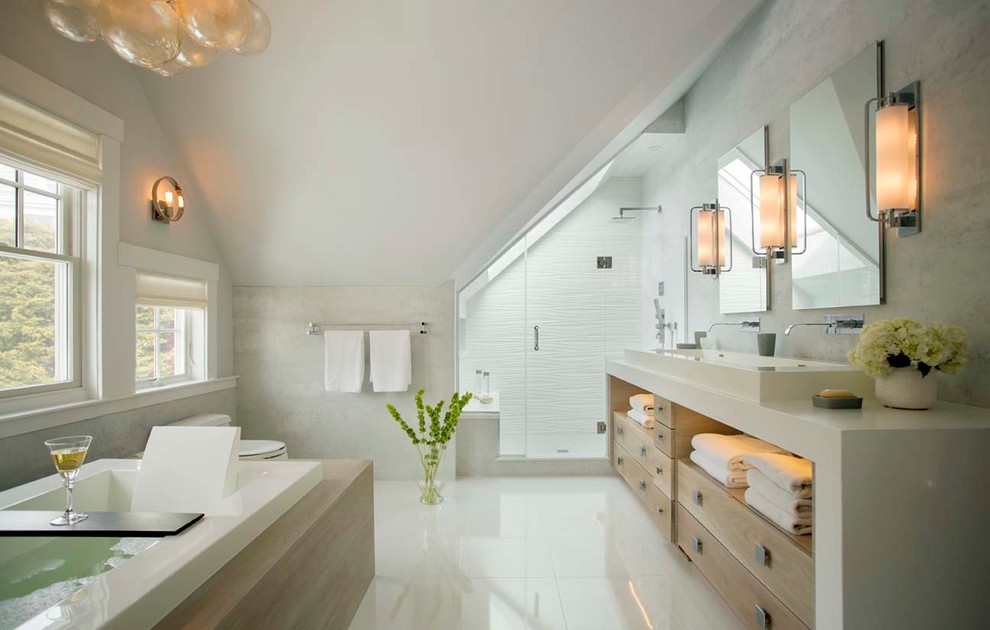This is an example of a large beach style master bathroom in Boston with a trough sink, light wood cabinets, a drop-in tub, an alcove shower, white tile, open cabinets, a one-piece toilet, porcelain tile, grey walls, engineered quartz benchtops, white floor, a hinged shower door and beige benchtops.