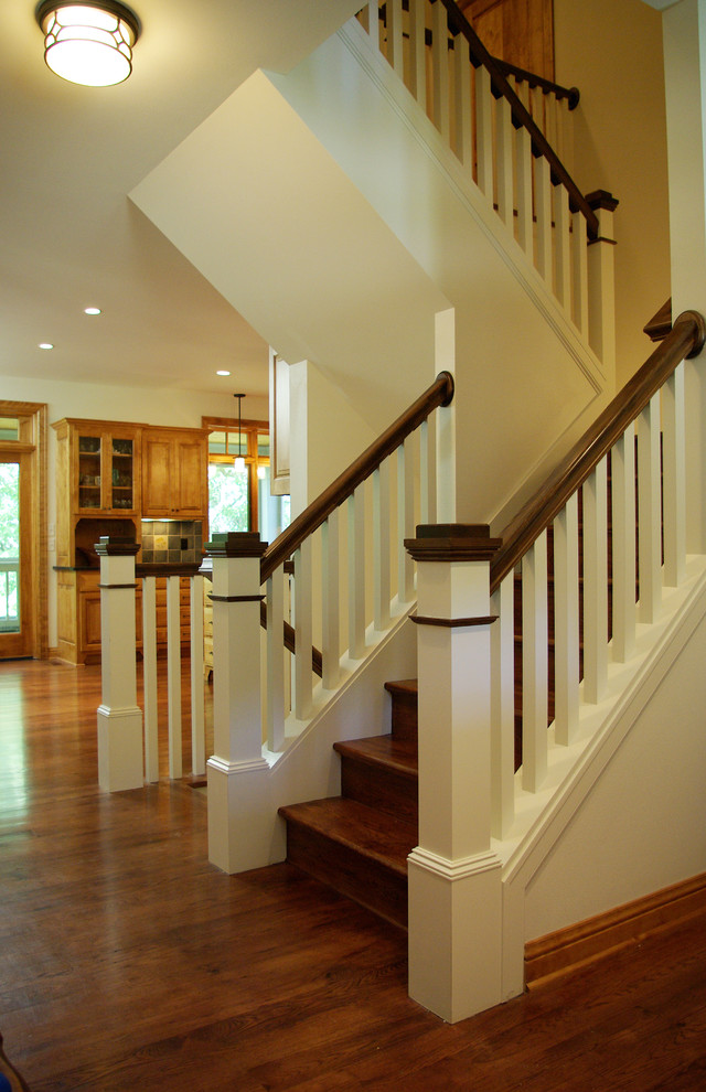 This is an example of a mid-sized traditional wood u-shaped staircase in Milwaukee with wood risers.