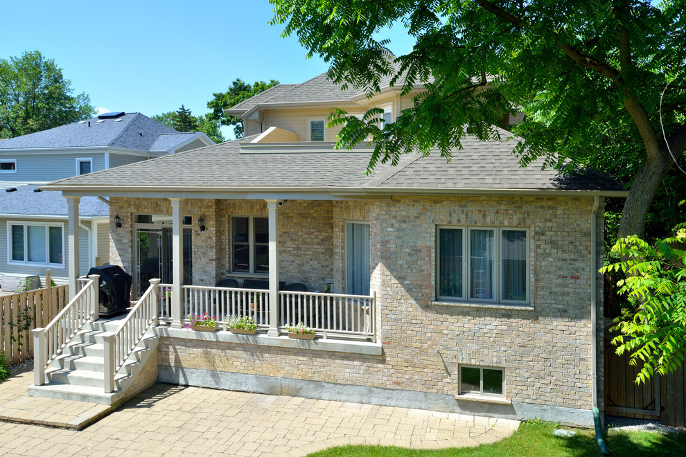 This is an example of a traditional brick beige exterior in Toronto with a gable roof.
