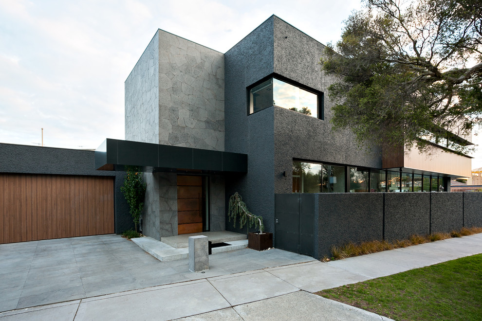 Photo of a large contemporary two-storey stucco grey exterior in Melbourne.