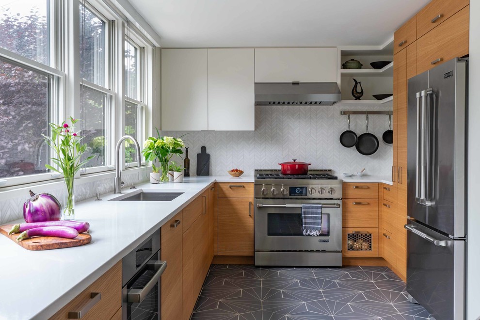 Design ideas for a midcentury u-shaped kitchen in New York with an undermount sink, flat-panel cabinets, light wood cabinets, quartz benchtops, white splashback, marble splashback, stainless steel appliances, porcelain floors, grey floor, white benchtop and no island.