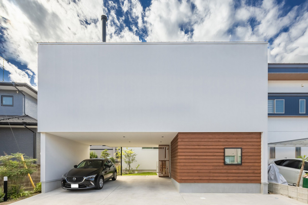 На фото: двухэтажный, белый частный загородный дом в стиле модернизм с облицовкой из металла, односкатной крышей, металлической крышей, белой крышей и отделкой доской с нащельником с