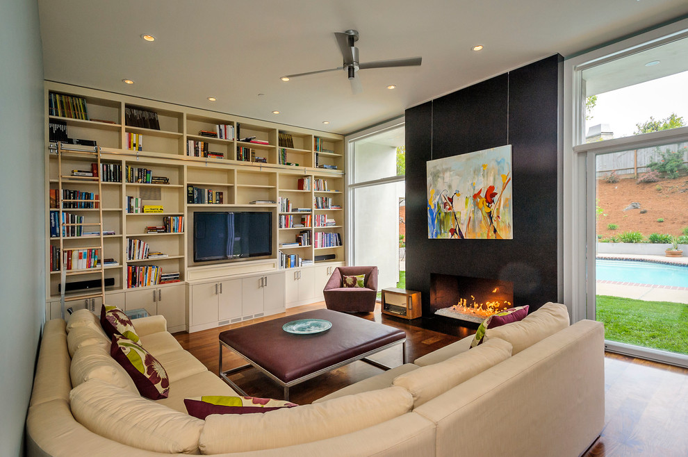 Contemporary living room in San Francisco with a library.