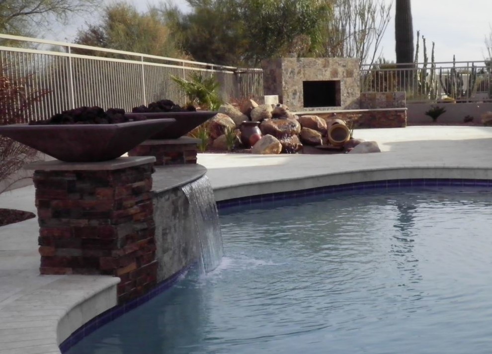 Example of a mid-sized classic backyard tile and custom-shaped lap pool fountain design in Phoenix
