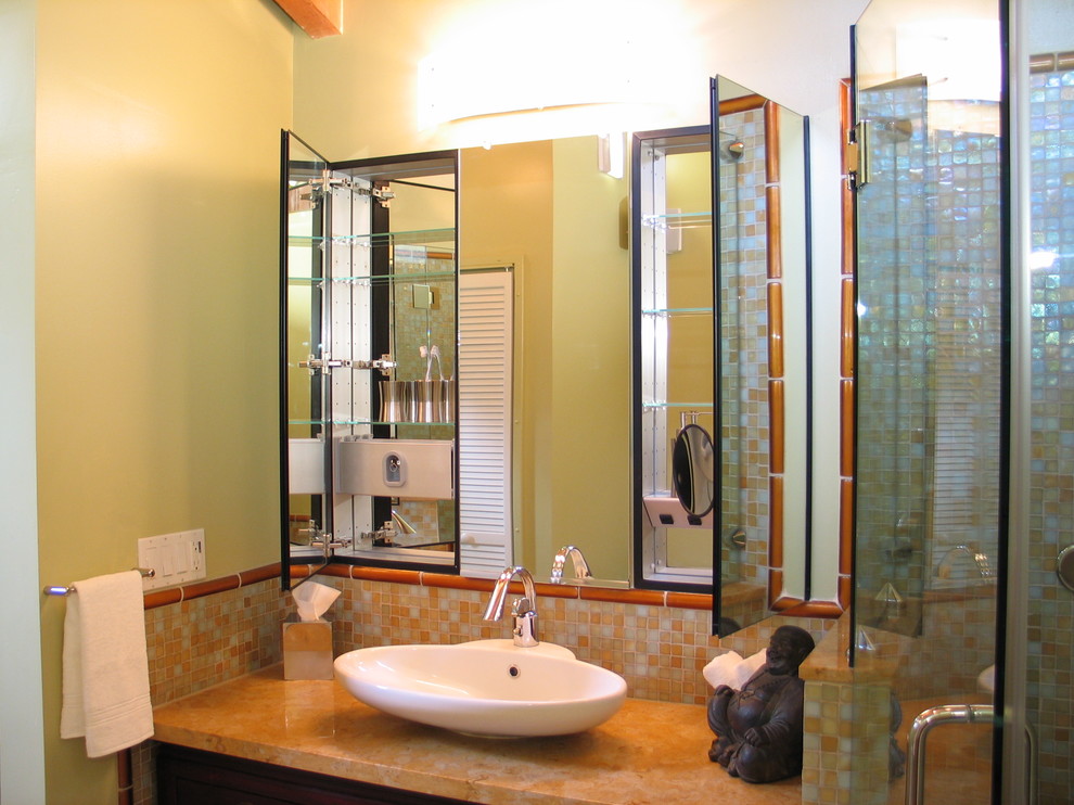 Photo of an asian master bathroom in San Francisco with mosaic tile, a vessel sink, flat-panel cabinets, dark wood cabinets, a drop-in tub, beige benchtops, a single vanity and a built-in vanity.