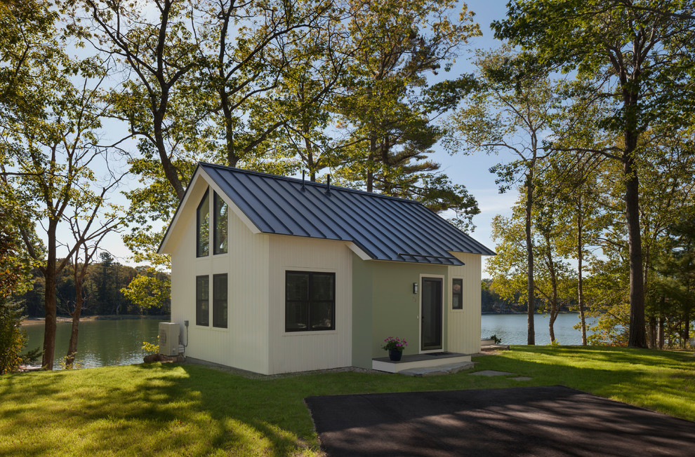 Photo of a small transitional one-storey house exterior in Portland Maine with a gable roof and a metal roof.