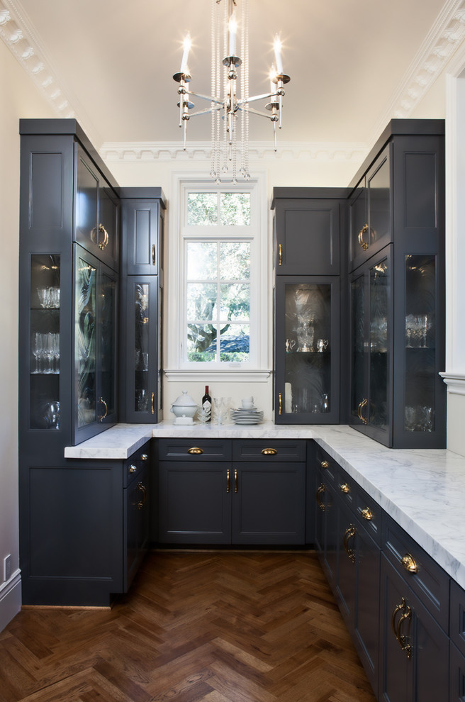 Inspiration for a traditional u-shaped home bar in San Francisco with shaker cabinets, black cabinets, dark hardwood floors and brown floor.