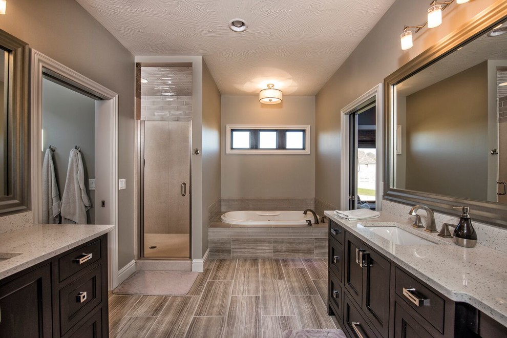 Large transitional master gray tile and glass tile porcelain tile drop-in bathtub photo with beaded inset cabinets, black cabinets, gray walls, an undermount sink and quartz countertops