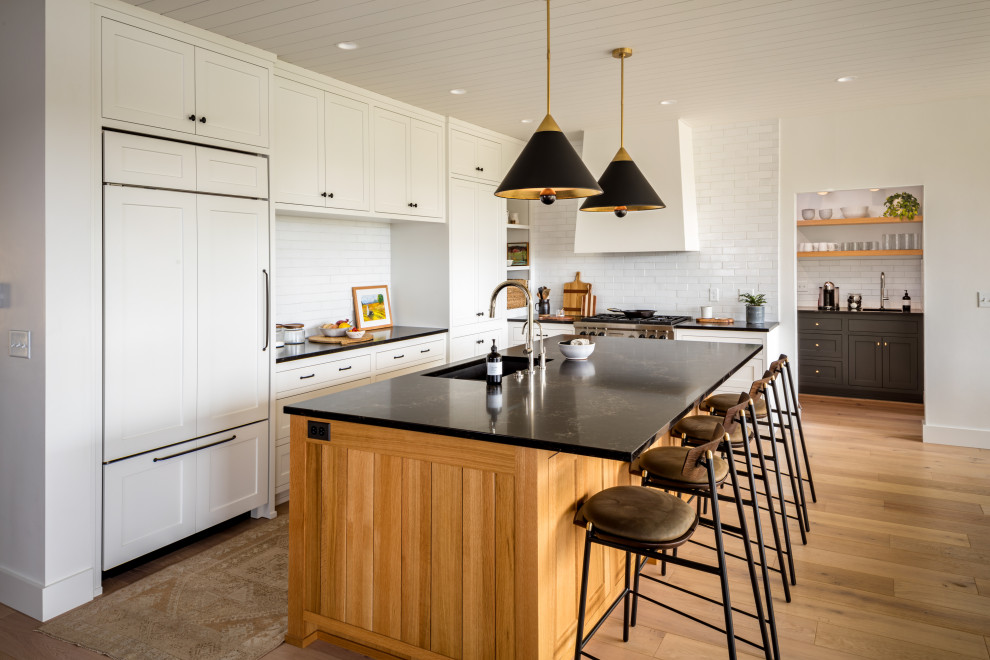 Inspiration for a mid-sized transitional u-shaped eat-in kitchen remodel with a drop-in sink, shaker cabinets, white cabinets and an island