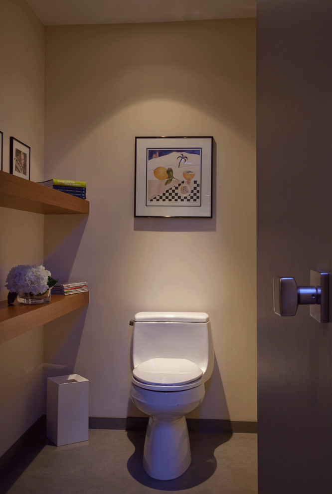 Photo of a large contemporary powder room in San Diego with a one-piece toilet, beige walls and porcelain floors.