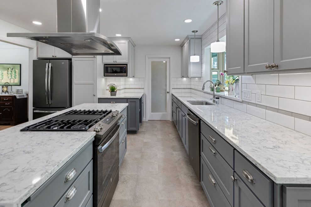 Inspiration for a mid-sized contemporary u-shaped eat-in kitchen in Other with an undermount sink, shaker cabinets, grey cabinets, quartzite benchtops, white splashback, ceramic splashback, stainless steel appliances, vinyl floors, with island, grey floor and grey benchtop.