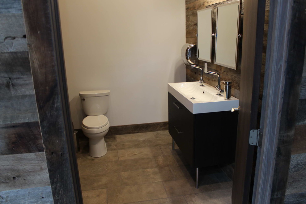 Small mediterranean 3/4 bathroom in Other with flat-panel cabinets, black cabinets, marble benchtops, a two-piece toilet, gray tile, stone tile, white walls and limestone floors.