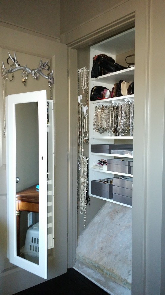Eclectic storage and wardrobe in Columbus with open cabinets and white cabinets.
