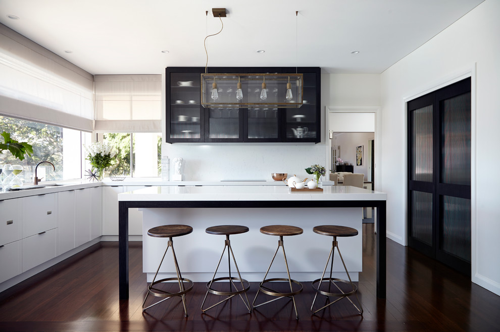 Inspiration for a transitional l-shaped eat-in kitchen in Sydney with an undermount sink, glass-front cabinets, white cabinets, quartz benchtops, white splashback, stone slab splashback, stainless steel appliances, dark hardwood floors and with island.