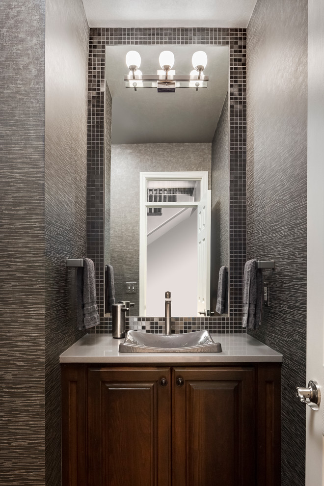 Small transitional bathroom in Kansas City with dark wood cabinets, engineered quartz benchtops, grey walls, a vessel sink, raised-panel cabinets, gray tile and metal tile.