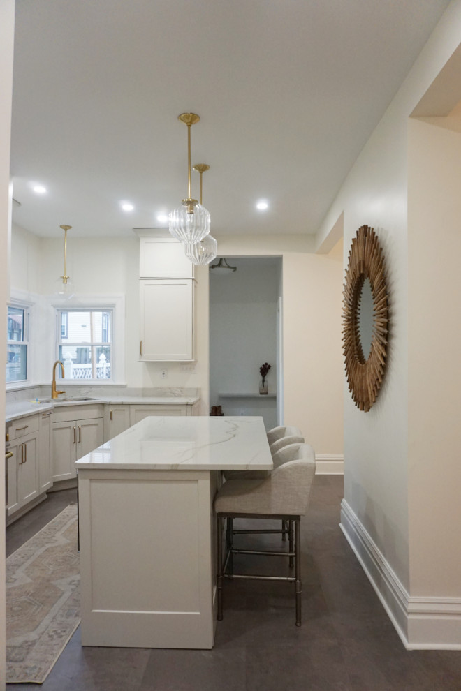 Kitchen - transitional vinyl floor and gray floor kitchen idea with an undermount sink, shaker cabinets, gray cabinets, quartzite countertops, stone slab backsplash, stainless steel appliances and an island