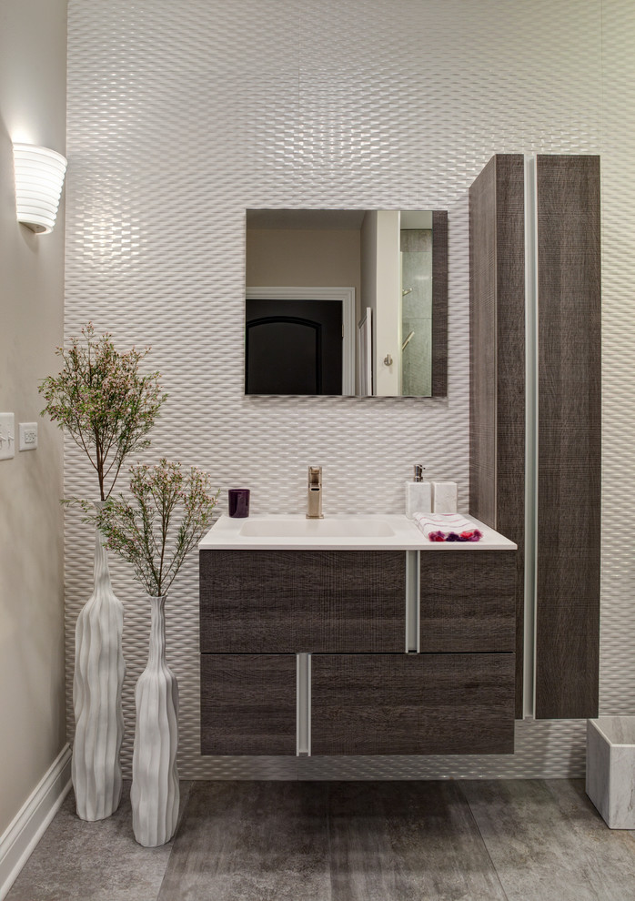 Inspiration for a mid-sized contemporary bathroom in Chicago with an integrated sink, dark wood cabinets, engineered quartz benchtops, white tile, porcelain tile, grey walls, porcelain floors and flat-panel cabinets.
