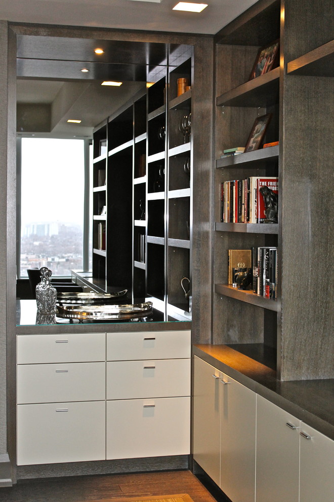 Contemporary home office in Toronto with dark hardwood floors and a built-in desk.