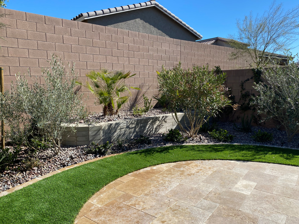 Design ideas for a mid-sized mediterranean backyard full sun garden in Las Vegas with natural stone pavers.